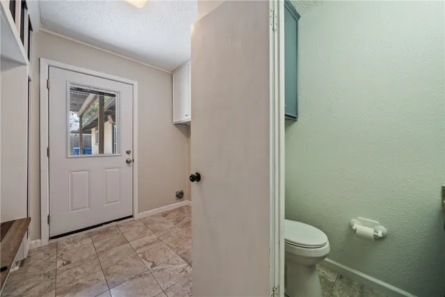 a view of kitchen with refrigerator and window