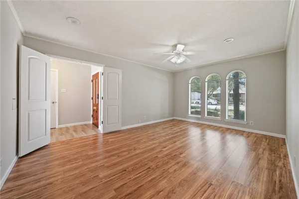 a view of an empty room with wooden floor