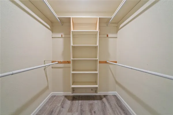 a view of a livingroom with wooden floor and window