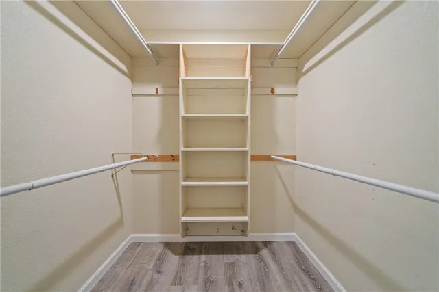 a view of a livingroom with wooden floor and window