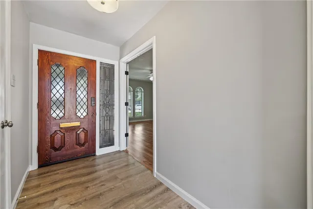 a view of an entryway with wooden floor