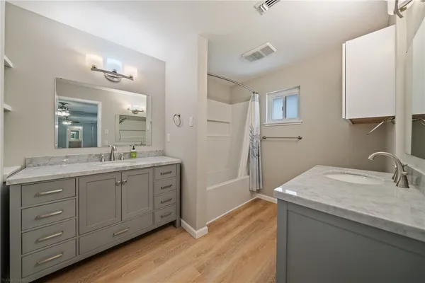 a bathroom with a granite countertop toilet sink and mirror