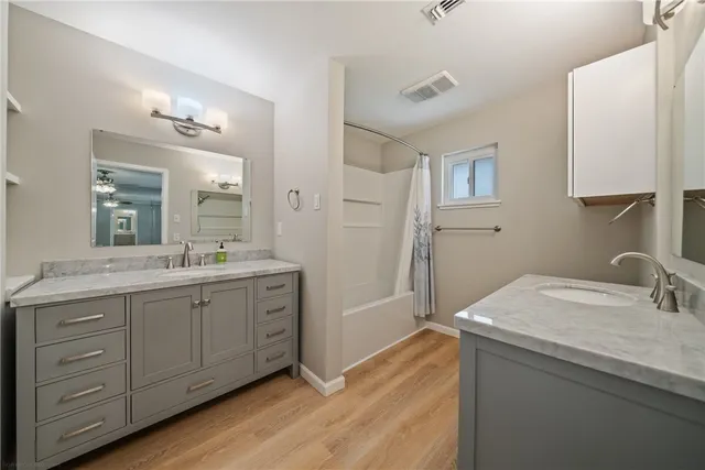 a bathroom with a granite countertop toilet sink and mirror