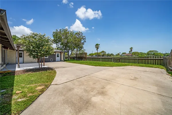 a view of house with backyard and a patio