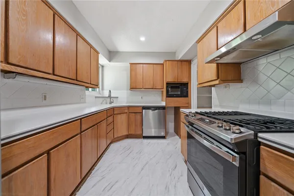 a kitchen with a sink a refrigerator and window
