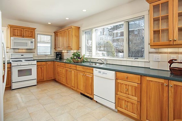 42 Lovell Road Watertown, MA 02472 - Photo 3 of 6 a kitchen with stainless steel appliances a stove sink and cabinets
