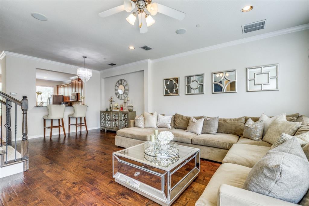 3932 Asbury Lane Addison, TX 75001 - Photo 3 of 18 a living room with furniture a rug and a chandelier
