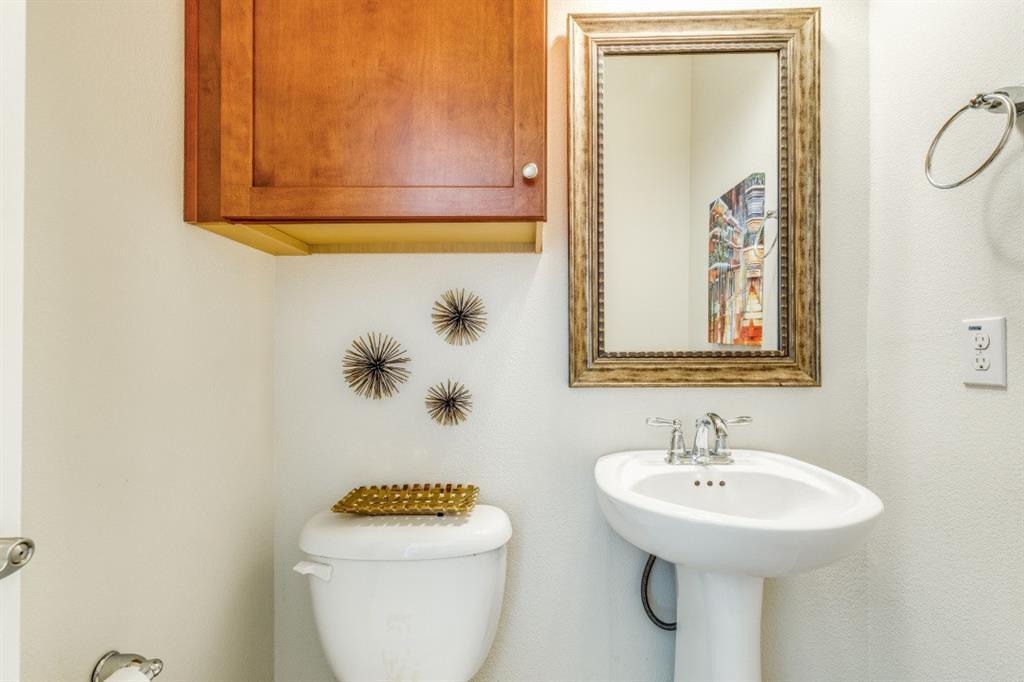 3932 Asbury Lane Addison, TX 75001 - Photo 5 of 18 a bathroom with a toilet sink and mirror