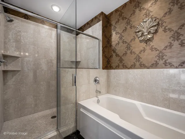 a bathroom with a bathtub and a shower