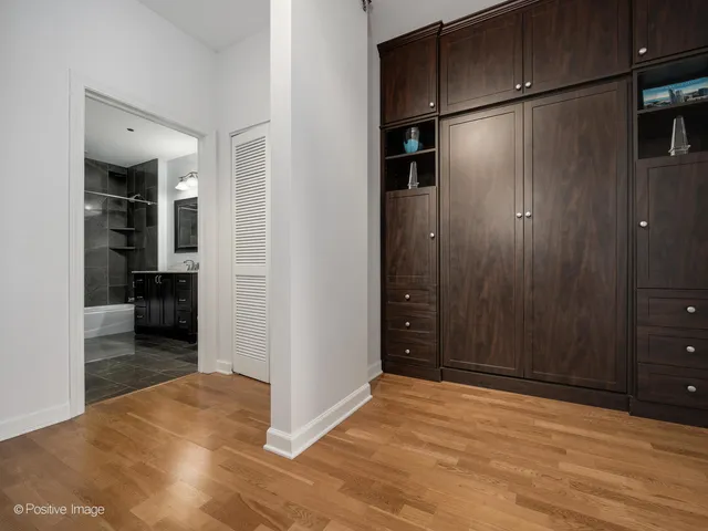 a view of a utility room with closet and cabinet