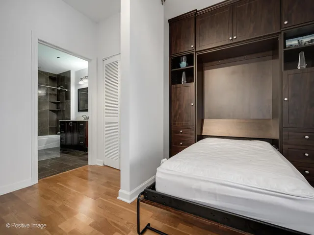 a bedroom with a bed and cabinets