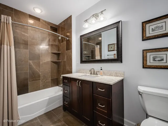 a bathroom with a toilet a sink and bathtub