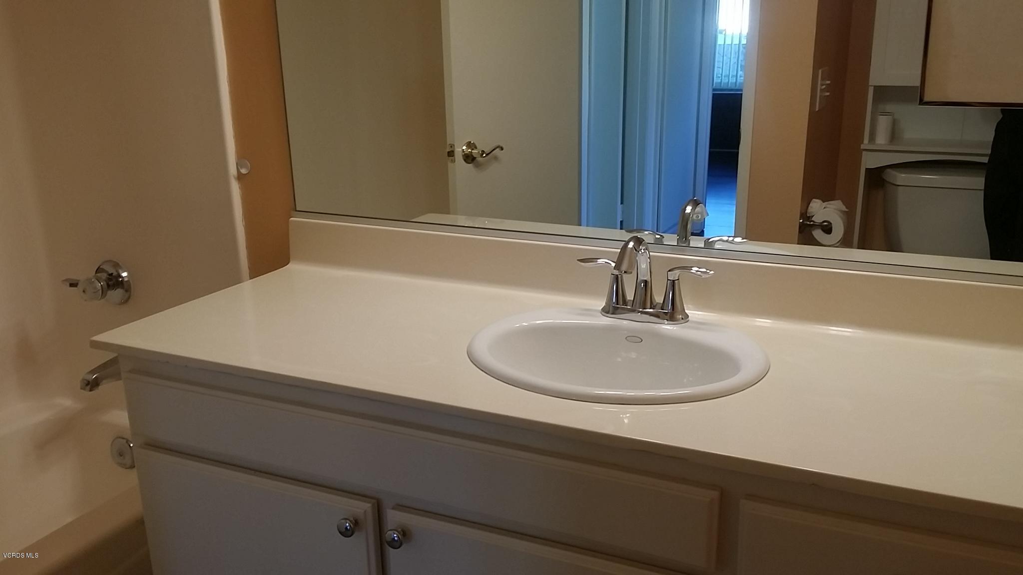 15076 Varsity Street, Unit C Moorpark, CA 93021 - Photo 13 of 18 a bathroom with a sink and a mirror