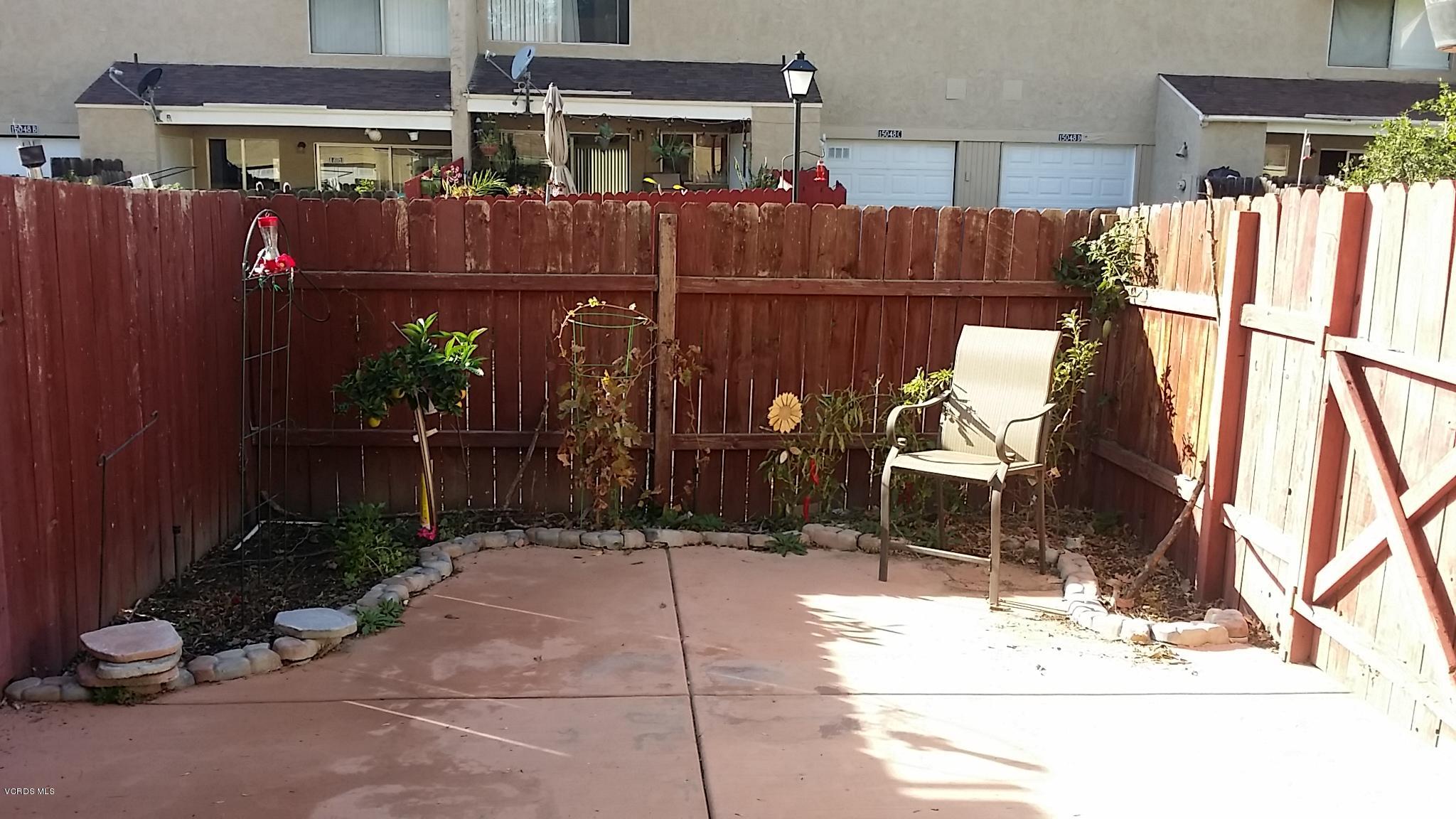 15076 Varsity Street, Unit C Moorpark, CA 93021 - Photo 17 of 18 a backyard of a house with yard and outdoor seating