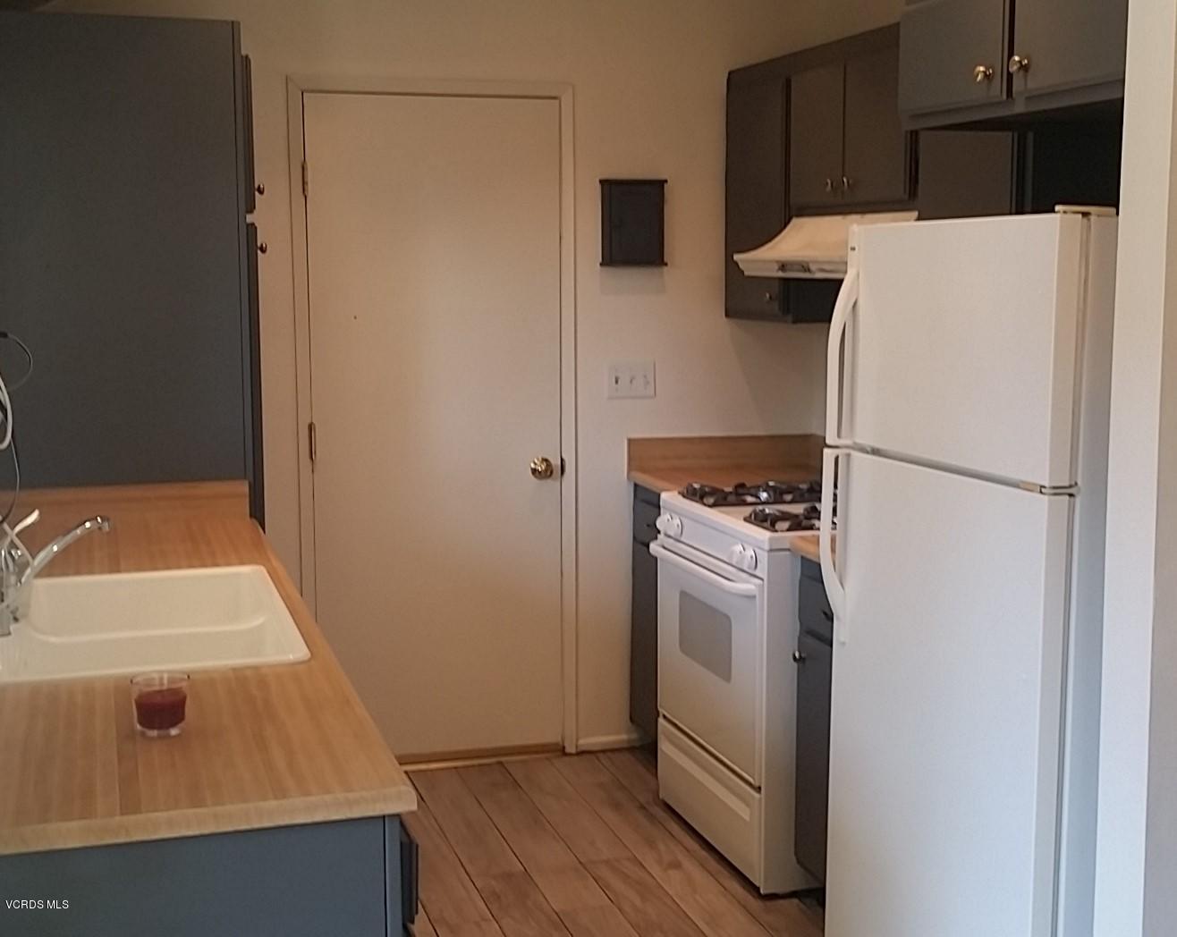 15076 Varsity Street, Unit C Moorpark, CA 93021 - Photo 4 of 18 a white refrigerator freezer and a stove sitting inside of a kitchen