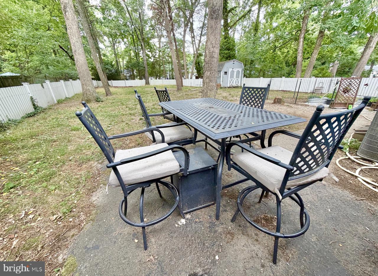 2413 Shelburn Road Millville, NJ 08332 - Photo 36 of 41 a view of a patio with a table chairs and a barbeque