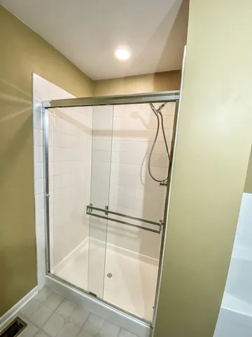 a bathroom with a glass shower door