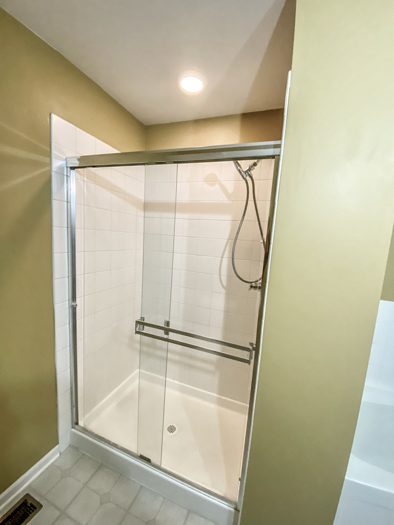 2249 Hudson Circle Aurora, IL 60502 - Photo 18 of 30 a bathroom with a glass shower door