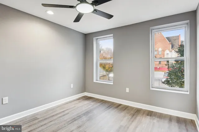 wooden floor in an empty room with a window