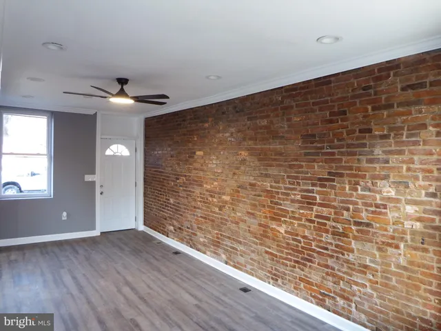 a view of an empty room and wooden floor