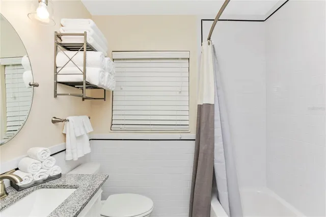 a living room with furniture and a mirror