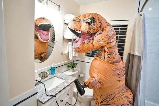 a bed sitting in a bedroom next to a lamp