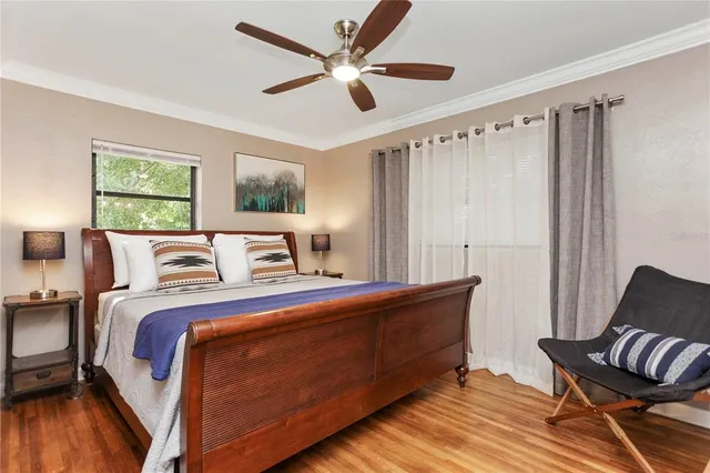 a bedroom with a large bed and a chandelier