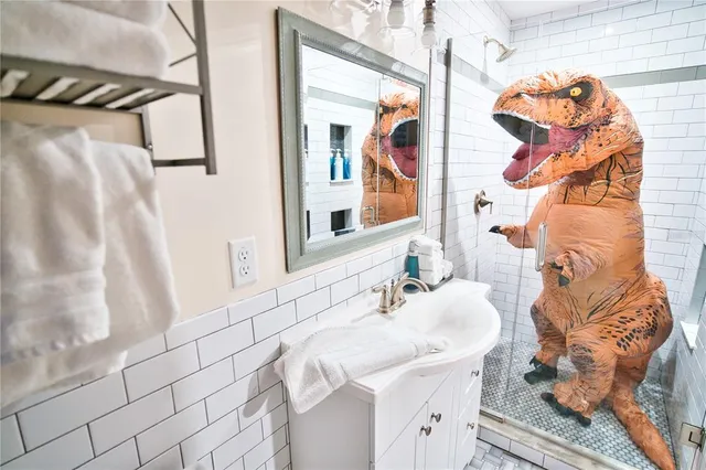 a dining room with wooden floor a chandelier a wooden table and chairs