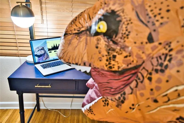 a view of a big room with wooden floor and furniture