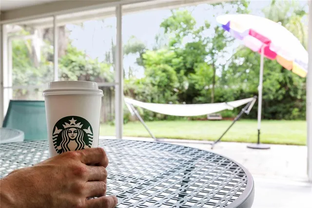 a view of a porch with furniture and a yard