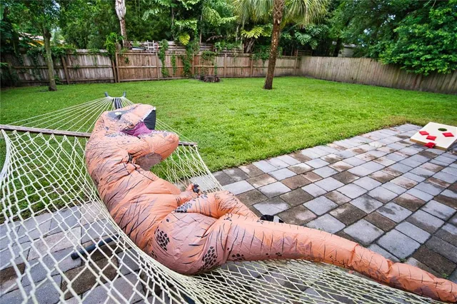 a view of a patio with a table and chairs under an umbrella