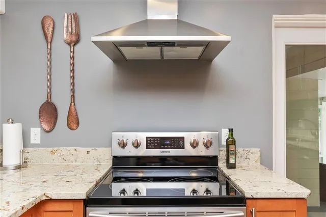 a kitchen with a stove and a dining table