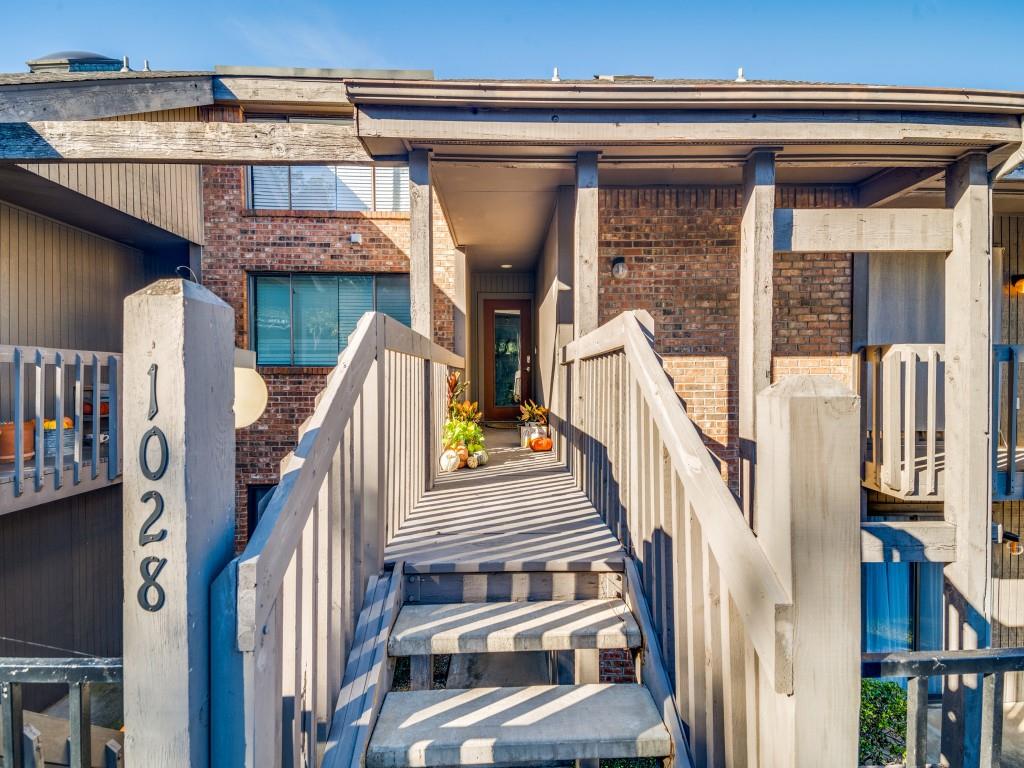 a view of a balcony with furniture and wooden floor