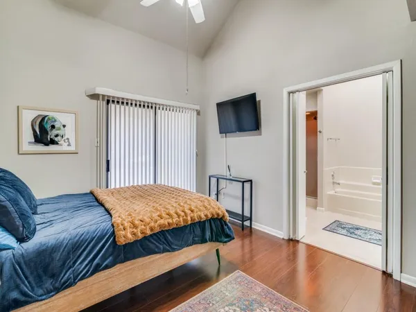 a bedroom with a bed and a television