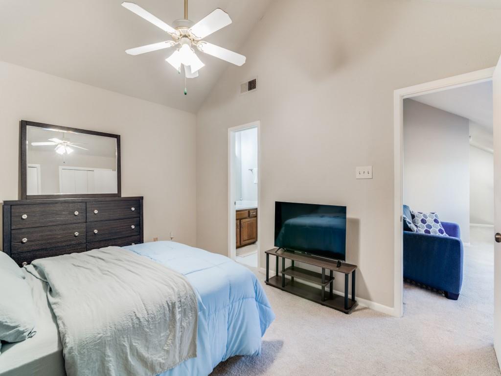 1028 Signal Ridge Place Rockwall, TX 75032 - Photo 22 of 27 a bedroom with a bed and a flat screen tv