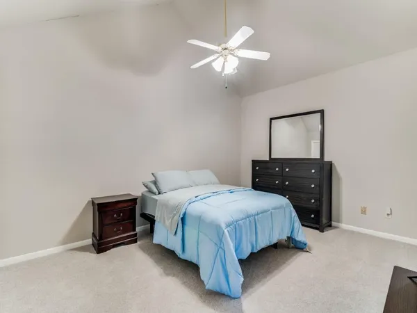 a bedroom with a bed and a night stand