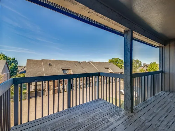 a balcony with wooden floor