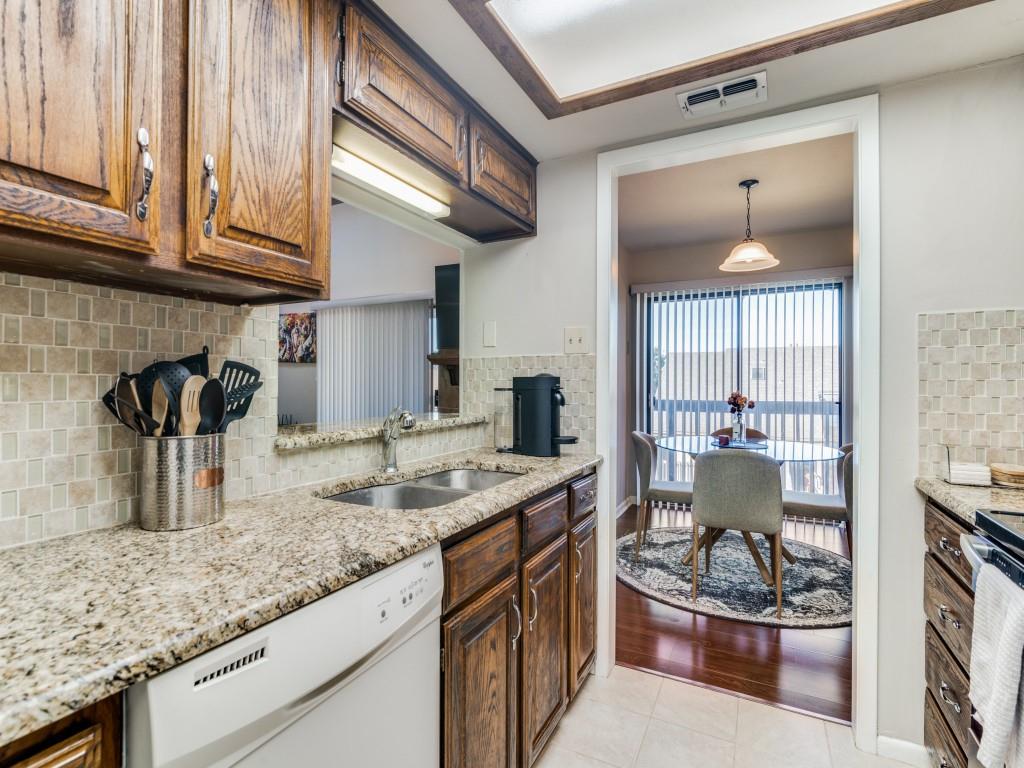 1028 Signal Ridge Place Rockwall, TX 75032 - Photo 6 of 27 a kitchen with a stove a faucet and a refrigerator