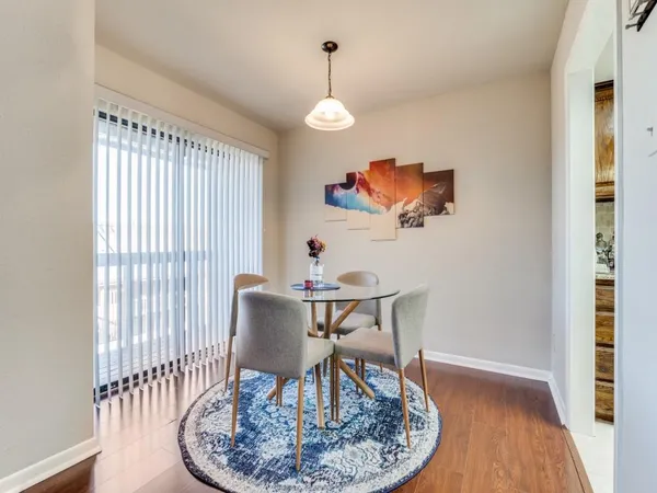a view of a dining room with furniture wooden floor and a chandelier