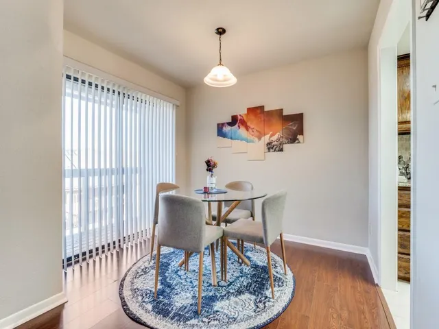 a view of a dining room with furniture wooden floor and a chandelier
