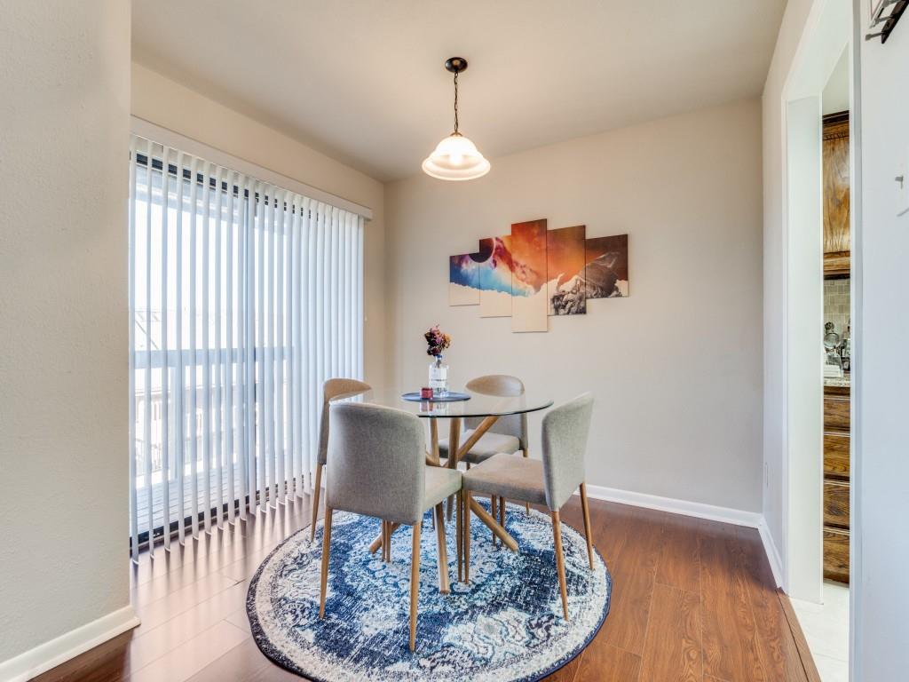 1028 Signal Ridge Place Rockwall, TX 75032 - Photo 7 of 27 a view of a dining room with furniture wooden floor and a chandelier