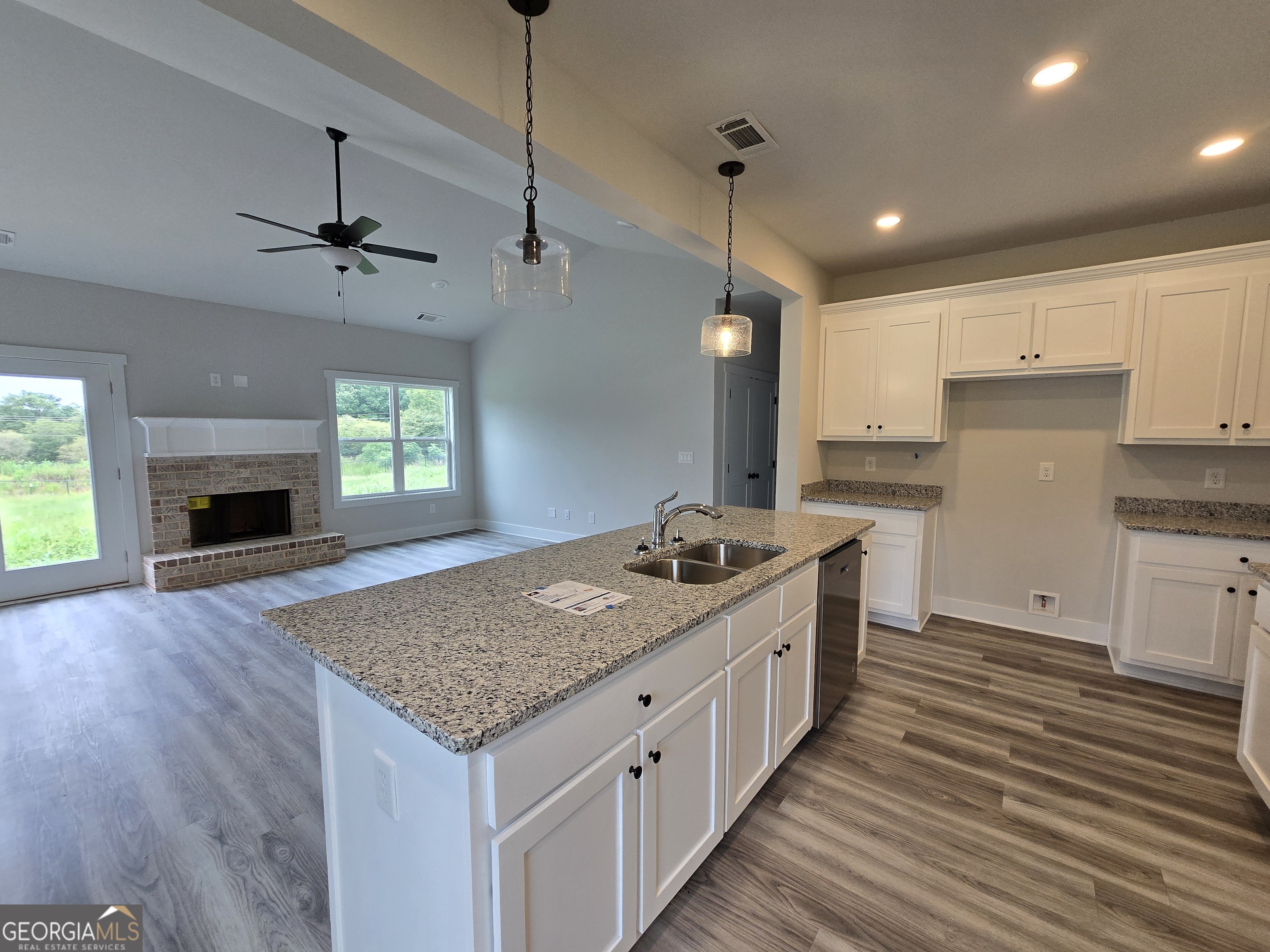 1041 Alaina Avenue, Unit 69 Madison, GA 30650 - Photo 11 of 20 a kitchen with sink stove and refrigerator