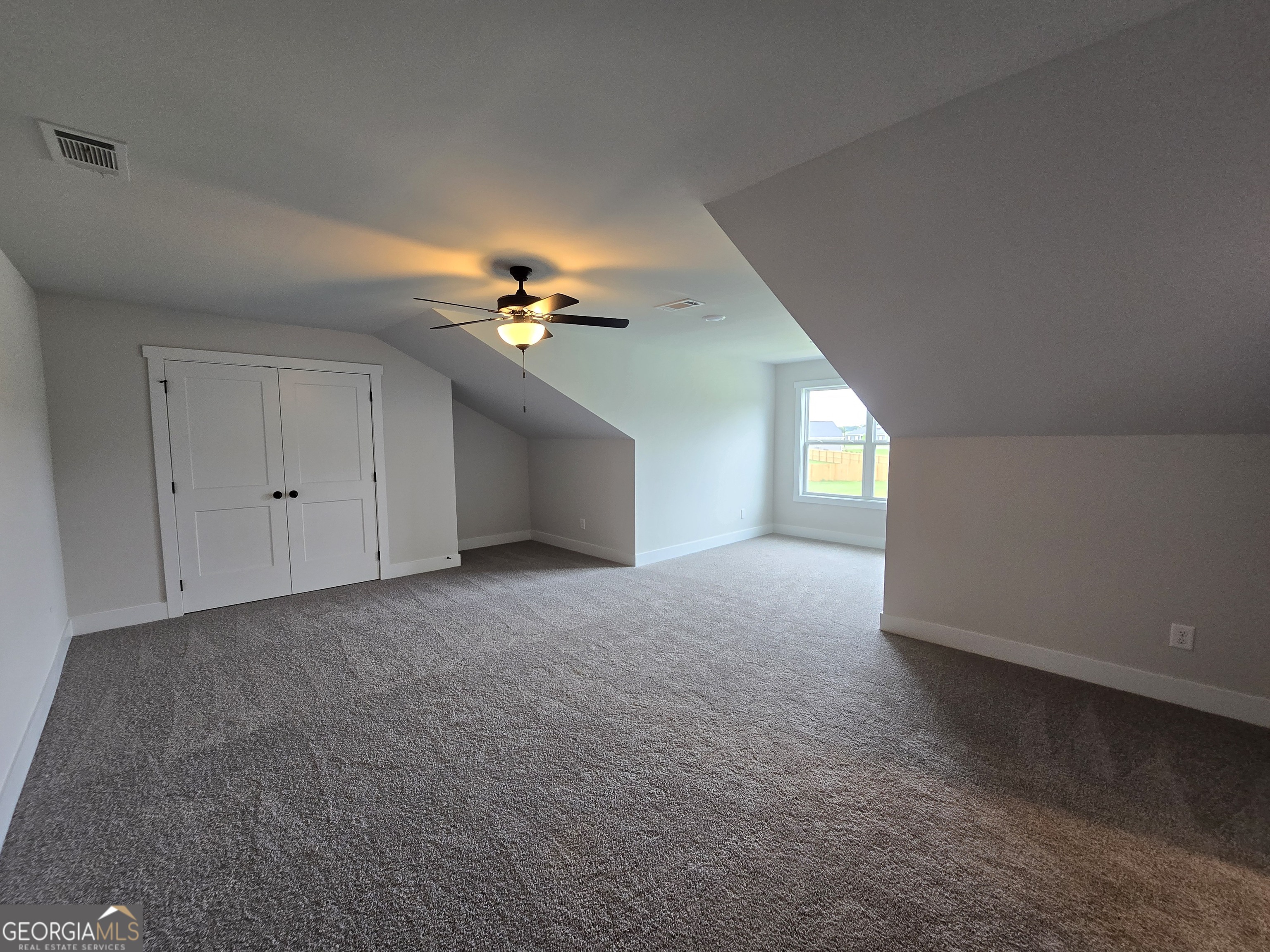 1041 Alaina Avenue, Unit 69 Madison, GA 30650 - Photo 16 of 20 a view of an empty room with a window