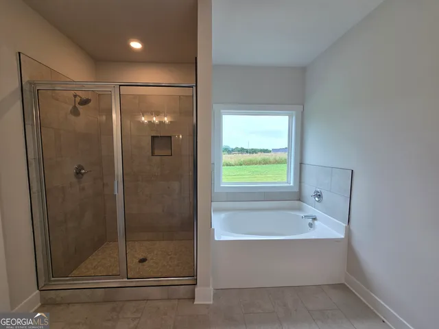 a bathroom with a bathtub and a shower