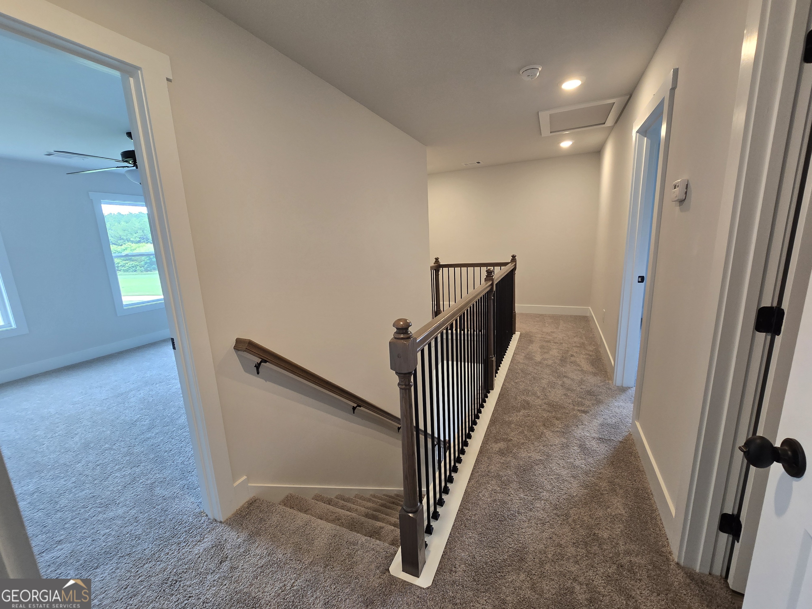 1041 Alaina Avenue, Unit 69 Madison, GA 30650 - Photo 19 of 20 a view of a hallway with stairs