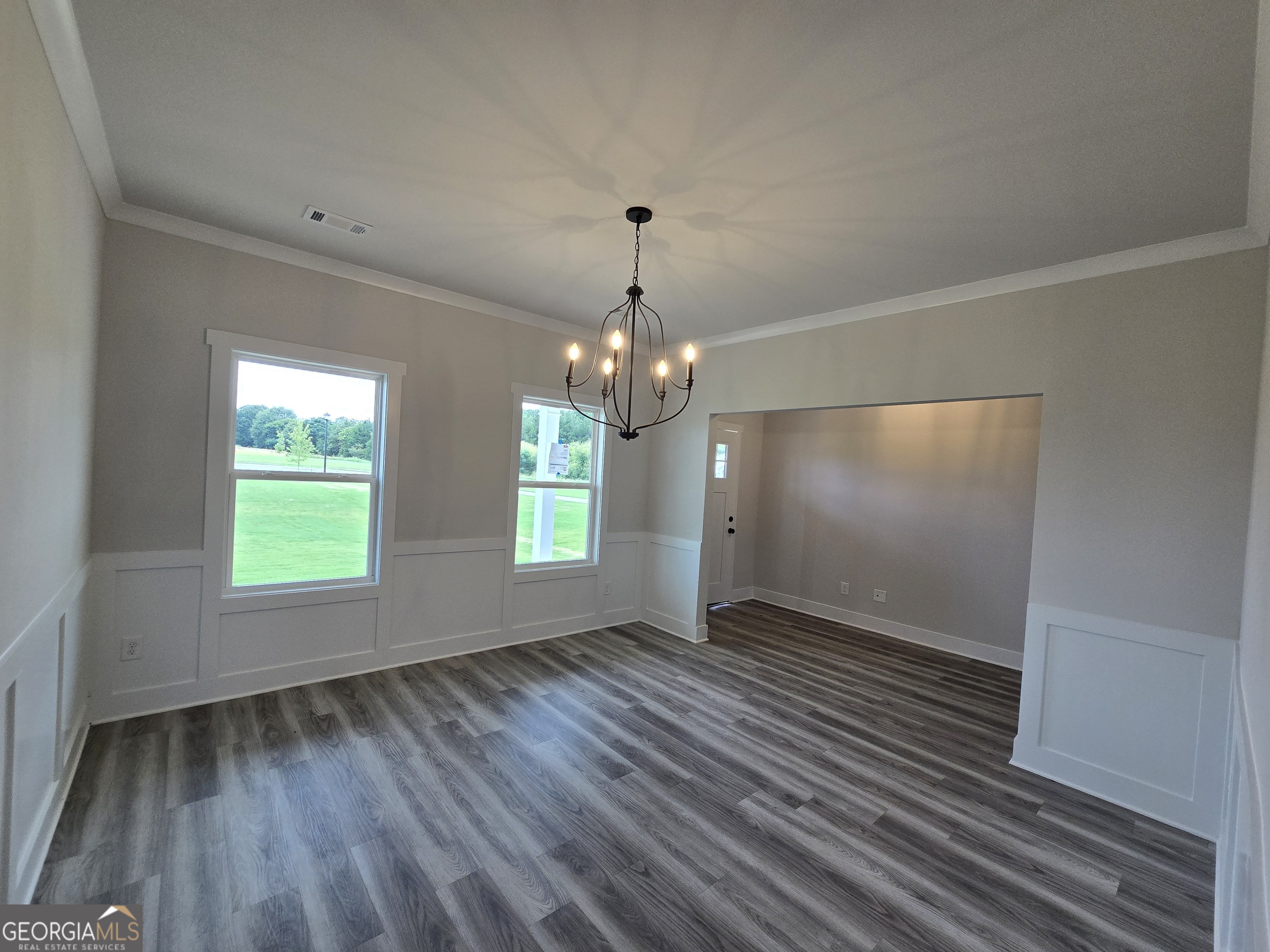 1041 Alaina Avenue, Unit 69 Madison, GA 30650 - Photo 3 of 20 wooden floor in an empty room with a window