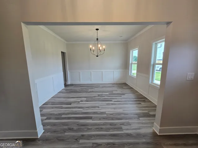 a view of an entryway with wooden floor