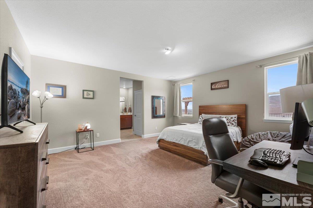 10457 Claim Jumper Way Reno, NV 89521 - Photo 23 of 39 a bedroom with furniture and a flat screen tv
