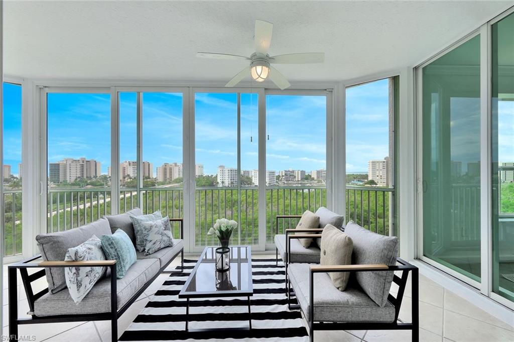 300 Dunes Boulevard, Unit 605 Naples, FL 34110 - Photo 12 of 37 a living room with furniture and floor to ceiling windows