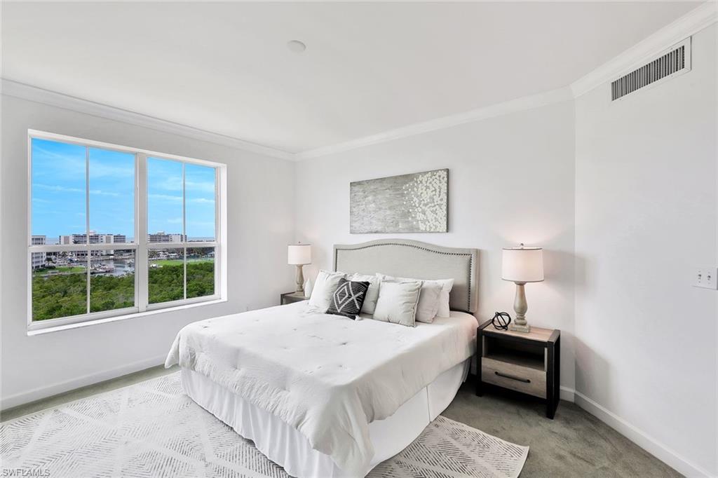300 Dunes Boulevard, Unit 605 Naples, FL 34110 - Photo 14 of 37 a bedroom with a large bed and a window